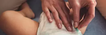 Parent changing infant diaper